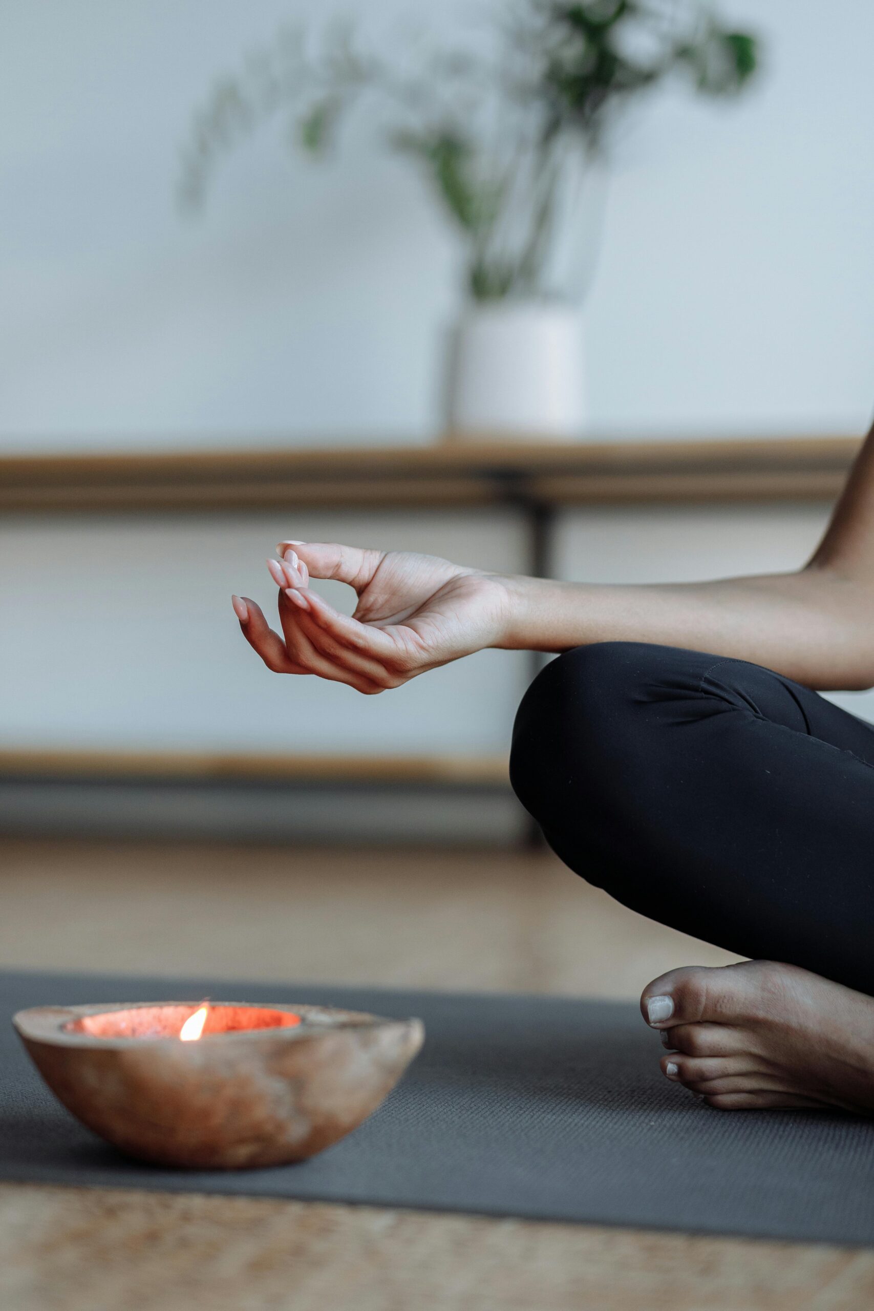 a lit candle sitting on top of a wooden table